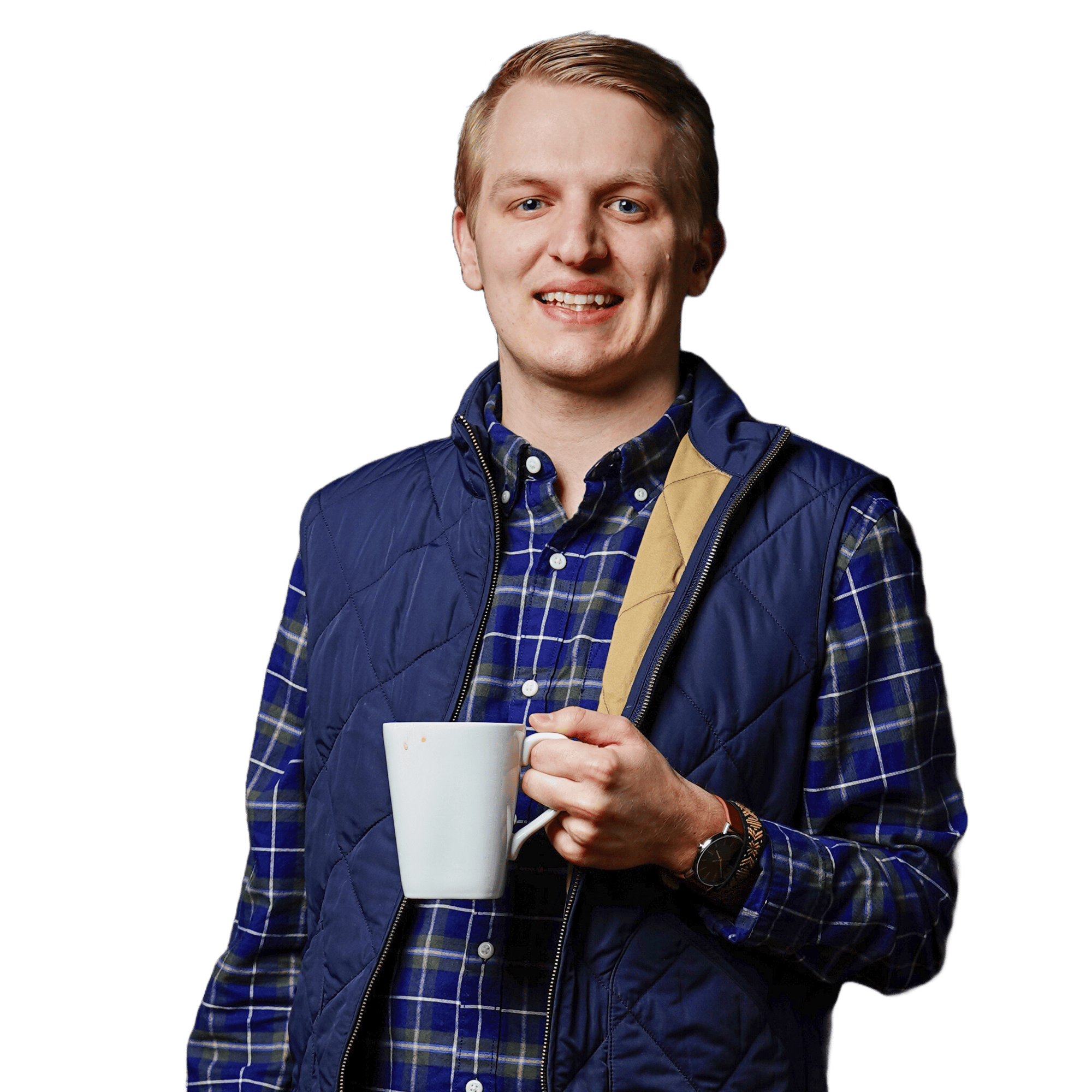 A person in a plaid shirt and blue vest, perhaps a creative at one of the leading MN software companies, holds a white mug, smiling against a plain background.