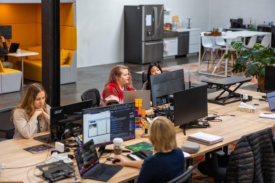 The Compoze Labs delivery team working at their desks in the office