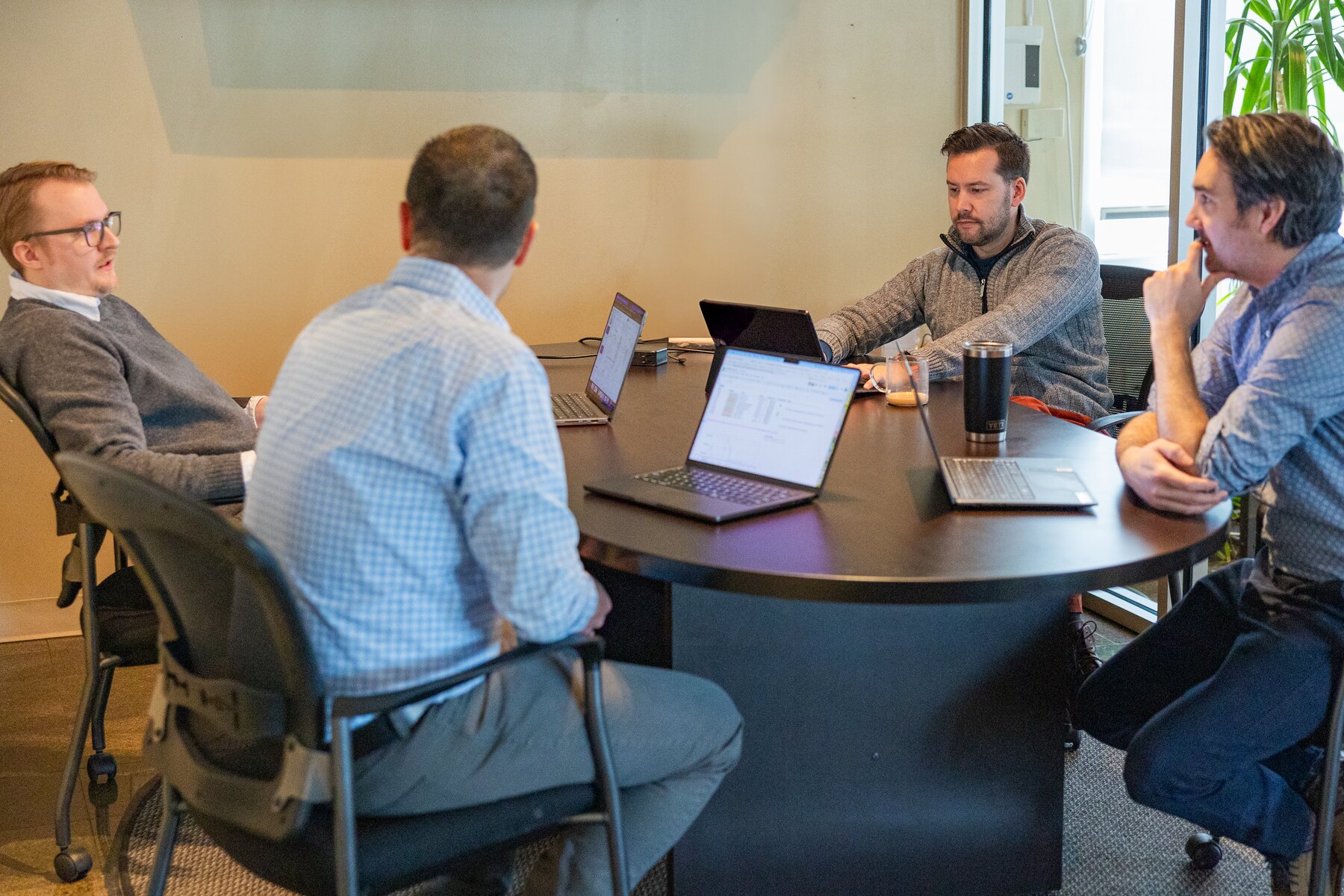 Compoze Labs team members working together at laptops